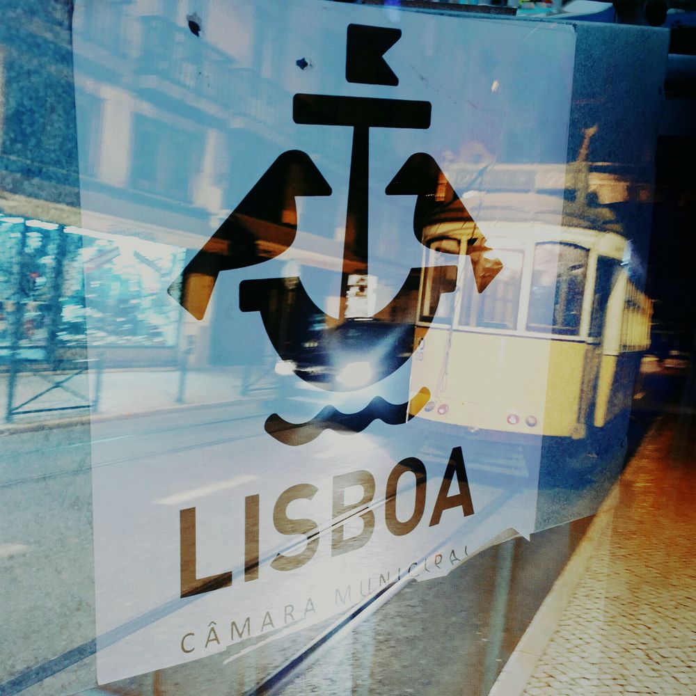 Lisbon double exposure with tram and sign